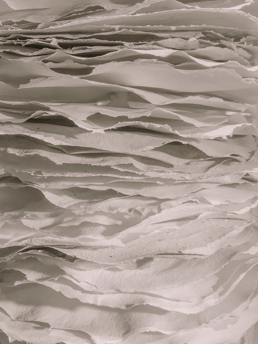 Stacked white papers creating abstract texture
