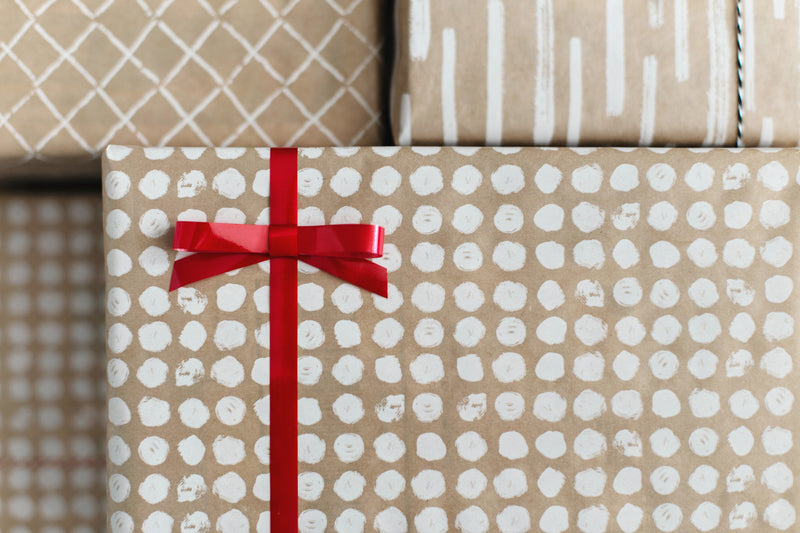 Wrapped holiday gift with red ribbon best gifts for couples