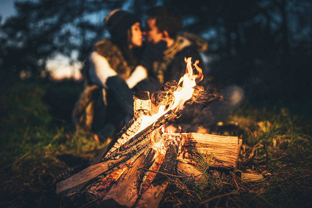 Person sitting by campfire on date