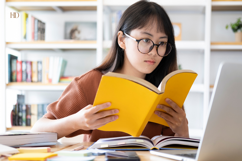 Young woman reading a book focused