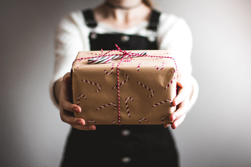 Person holding gift with red string gifts for people who love organization