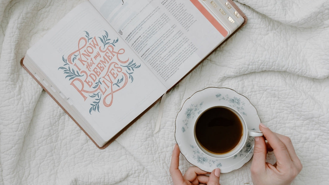 Coffee mug and open book