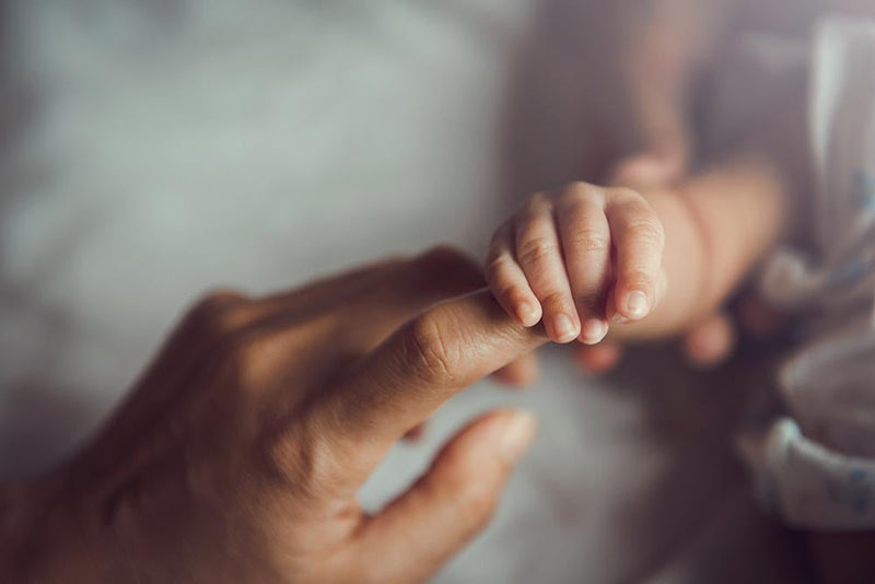 Close-up of hands painting nails new mom hacks