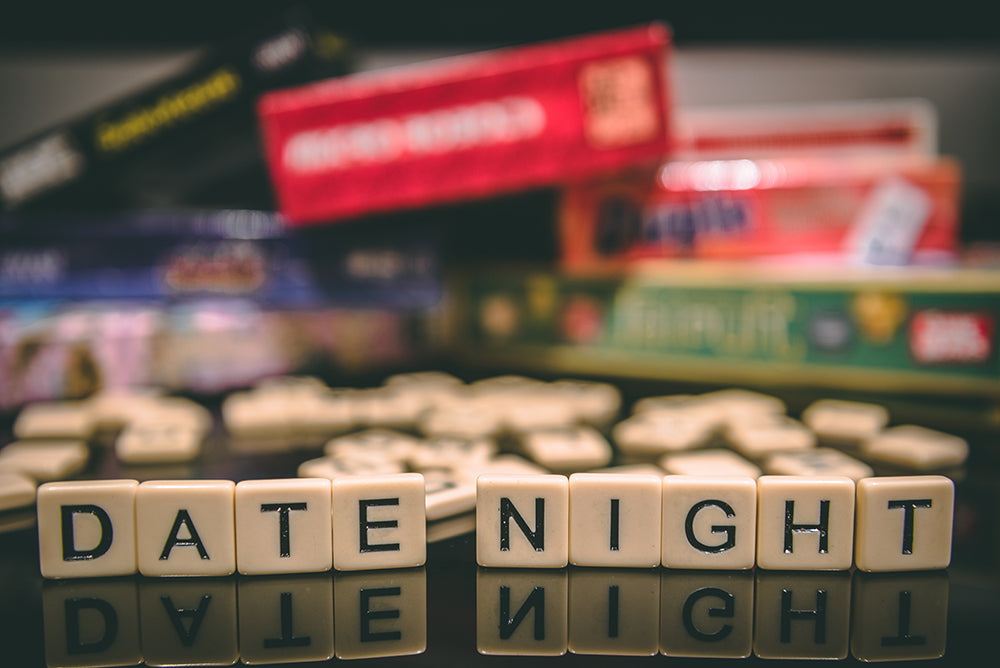 Scrabble tiles spelling 'DATE NIGHT'