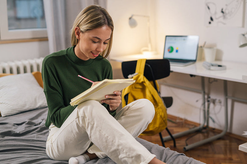 Woman reading book in cozy room dorm room organization