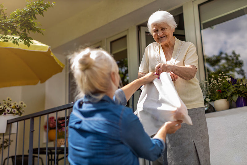 random acts of kindness Older woman holding hands with caregiver