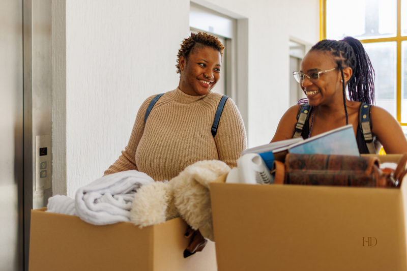 Two women packing boxes for moving