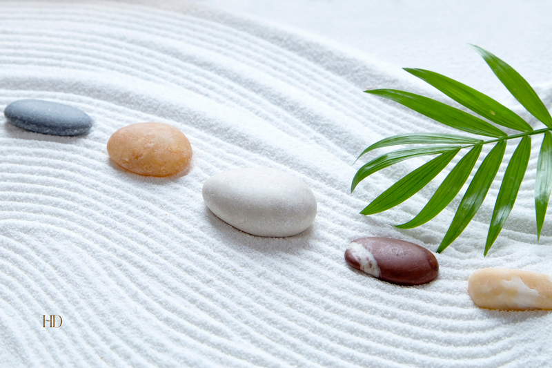 Smooth stones arranged on soft sand