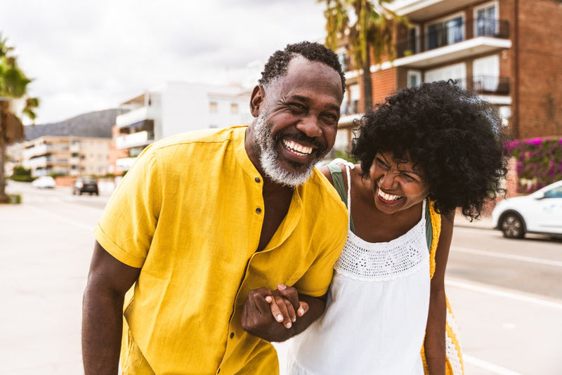 A happy couple enjoying a sunny afternoon walk together, illustrating creative day date ideas to build a closer relationship.