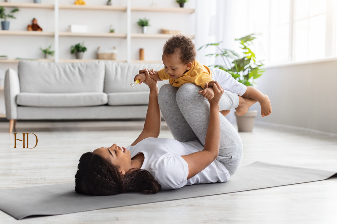 postpartum recovery timeline Mother playing with her child on the floor