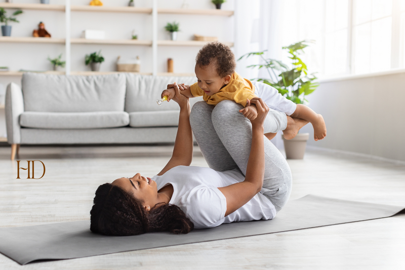 postpartum recovery timeline Mother playing with her child on the floor
