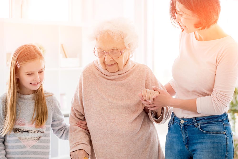 Elderly woman holding young hand