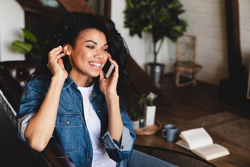 Woman smiling while talking on phone college freshman communication