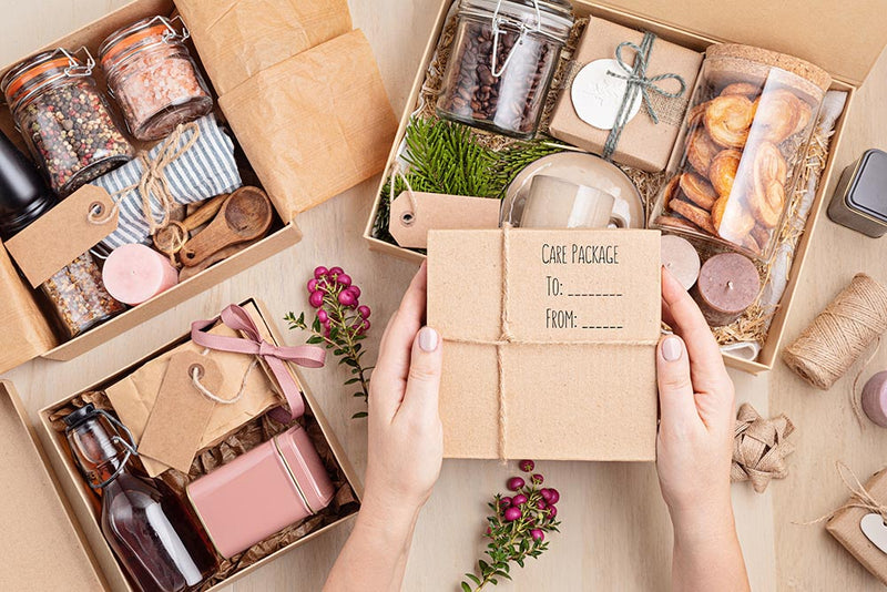 college care package ideas Hands holding college care package items