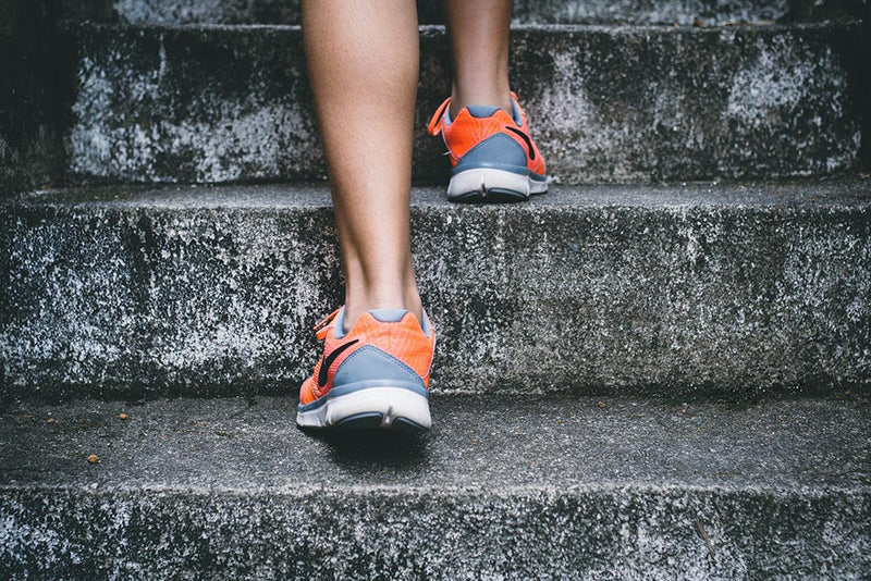 Student walking with orange backpack healthy habits for college students