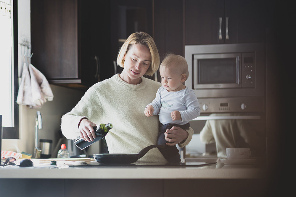 Mother and baby cooking together in the kitchen