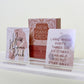 Two New Mama Deck prompt cards on a white surface with a light background and boxed packaging